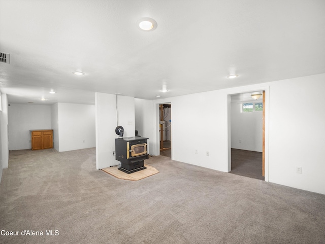 409 N 2nd St, Fairfield, WA 99012 - below grade area featuring a wood stove, carpet floors, and recessed lighting