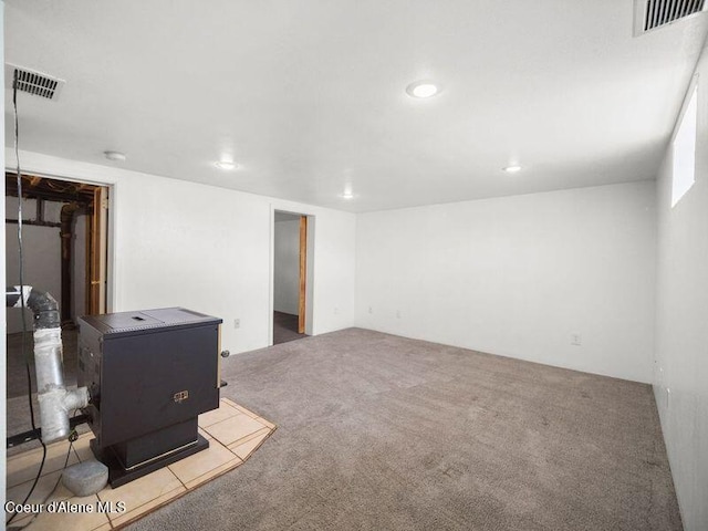 409 N 2nd St, Fairfield, WA 99012 - finished basement featuring a wood stove, recessed lighting, and carpet flooring