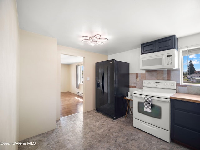 409 N 2nd St, Fairfield, WA 99012 - kitchen with white appliances, plenty of natural light, a baseboard radiator, and tasteful backsplash