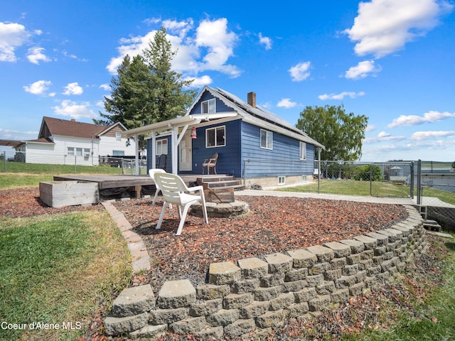 409 N 2nd St, Fairfield, WA 99012 - view of front of house featuring a chimney, roof mounted solar panels, and an outdoor fire pit