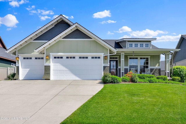 14774 N Pristine Cir, Rathdrum, ID 83858 - craftsman-style home with concrete driveway, a garage, a front lawn, board and batten siding, and covered porch