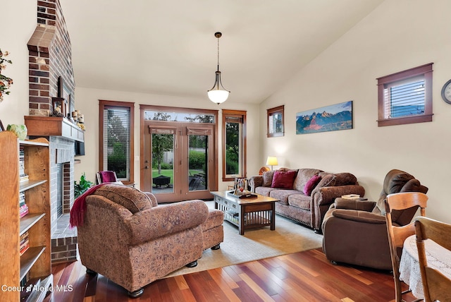 14774 N Pristine Cir, Rathdrum, ID 83858 - living area featuring a brick fireplace, healthy amount of natural light, hardwood / wood-style floors, and lofted ceiling