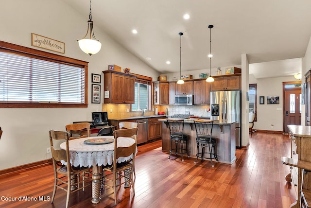 14774 N Pristine Cir, Rathdrum, ID 83858 - dining area featuring healthy amount of natural light, hardwood / wood-style flooring, lofted ceiling, recessed lighting, and baseboards