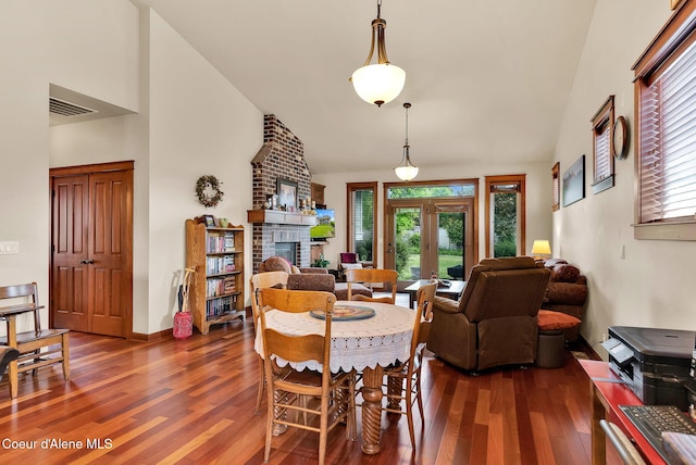 14774 N Pristine Cir, Rathdrum, ID 83858 - dining space featuring high vaulted ceiling, dark wood-type flooring, plenty of natural light, a fireplace, and french doors