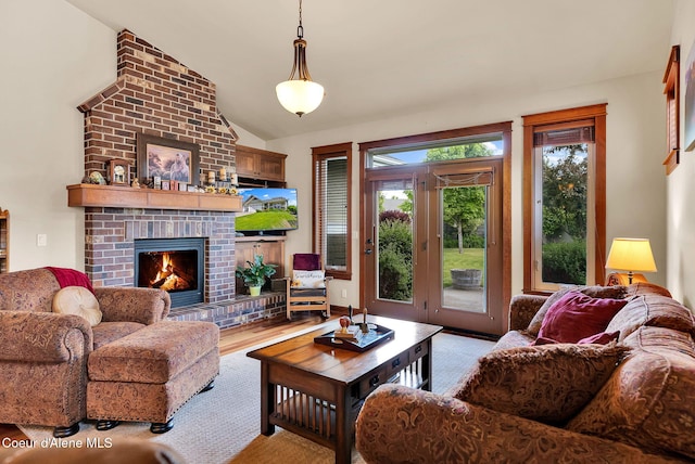 14774 N Pristine Cir, Rathdrum, ID 83858 - living area with lofted ceiling, a brick fireplace, and wood finished floors