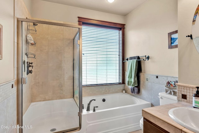 14774 N Pristine Cir, Rathdrum, ID 83858 - bathroom featuring a stall shower, a bath, tile walls, toilet, and vanity