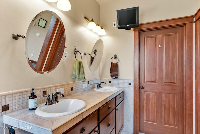 14774 N Pristine Cir, Rathdrum, ID 83858 - full bathroom featuring double vanity, tile walls, and wainscoting