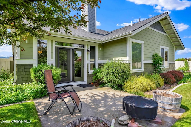 14774 N Pristine Cir, Rathdrum, ID 83858 - rear view of property featuring a patio area, a chimney, and a shingled roof