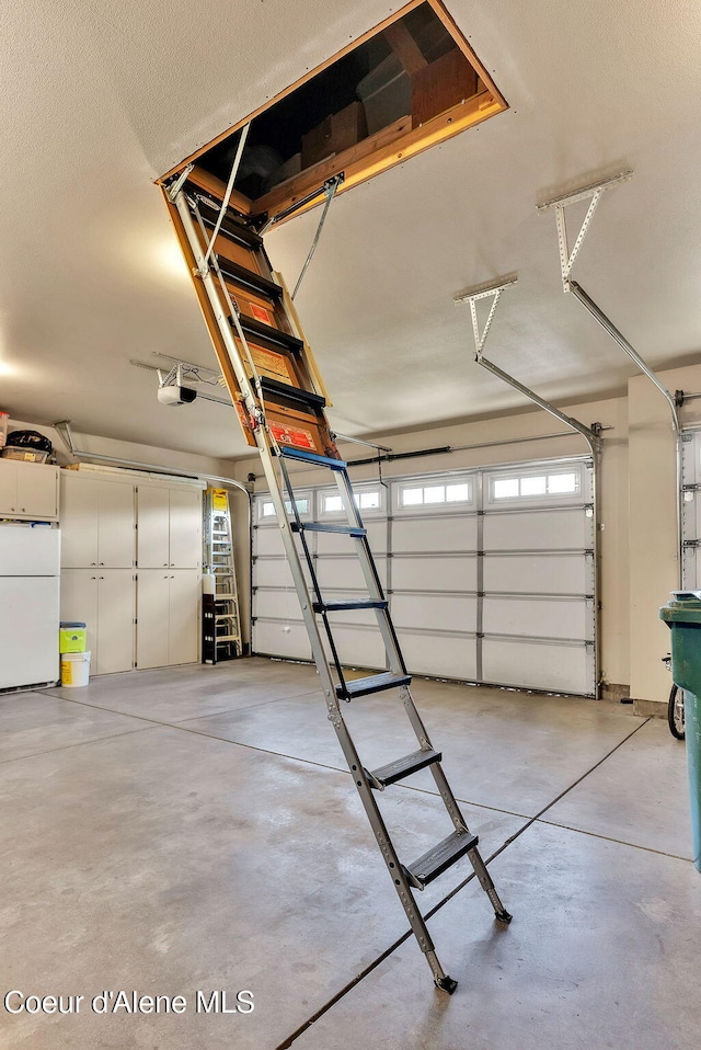 14774 N Pristine Cir, Rathdrum, ID 83858 - garage featuring freestanding refrigerator and a garage door opener
