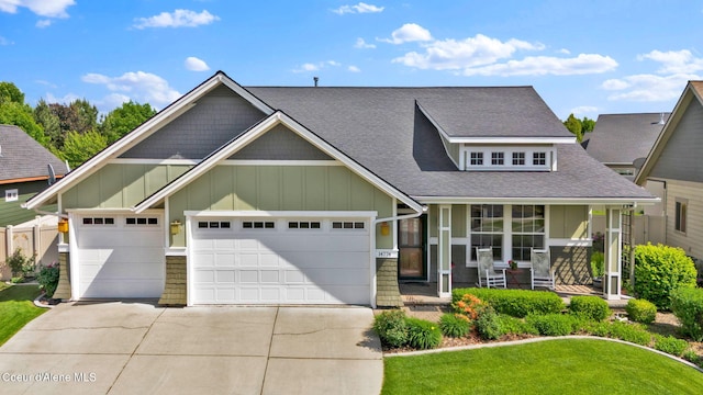 14774 N Pristine Cir, Rathdrum, ID 83858 - craftsman house featuring board and batten siding, covered porch, driveway, a garage, and roof with shingles