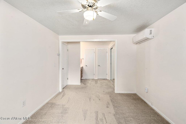 201 S Sequoia Ct, Post Falls, ID 83854 - unfurnished room featuring a wall mounted air conditioner, carpet floors, a textured ceiling, baseboards, and a ceiling fan