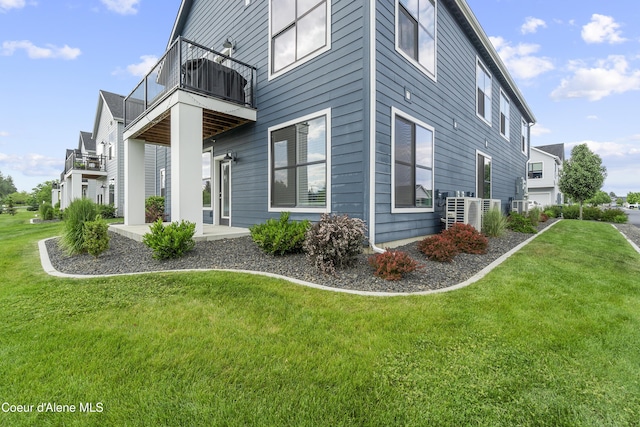 6430 N Atlas Rd Unit 101, Coeur Dalene, ID 83815 - view of side of home with a balcony and a yard