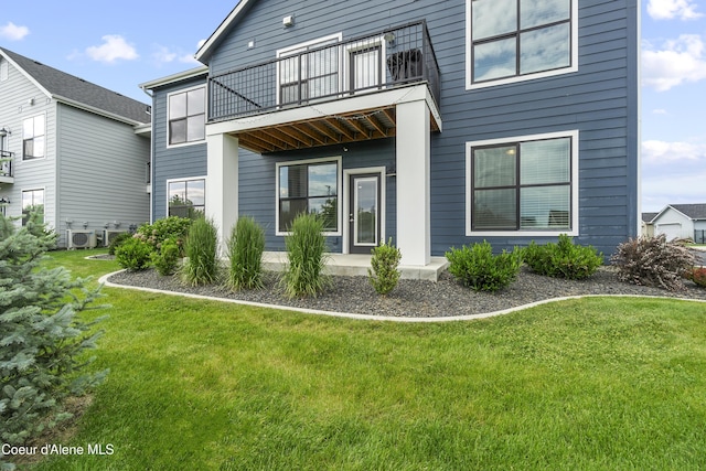 6430 N Atlas Rd Unit 101, Coeur Dalene, ID 83815 - back of house with a balcony and a lawn