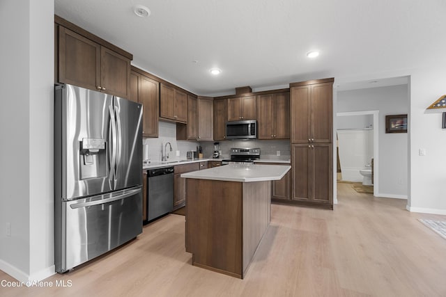 6430 N Atlas Rd Unit 101, Coeur Dalene, ID 83815 - kitchen featuring stainless steel appliances, a sink, light wood-style flooring, light countertops, and recessed lighting