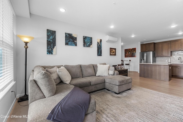6430 N Atlas Rd Unit 101, Coeur Dalene, ID 83815 - living area with light wood-type flooring, a wall unit AC, baseboards, and recessed lighting