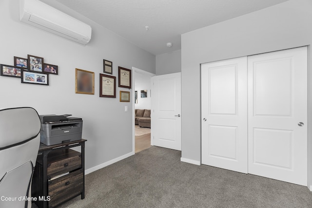 6430 N Atlas Rd Unit 101, Coeur Dalene, ID 83815 - home office featuring a wall unit AC, dark colored carpet, and baseboards