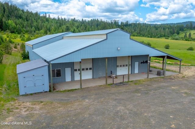 1995 Long Rd, Plummer, ID 83851 - view of outdoor structure featuring a forest view and central AC