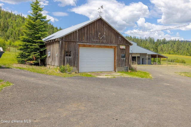1995 Long Rd, Plummer, ID 83851 - detached garage with dirt driveway and a forest view