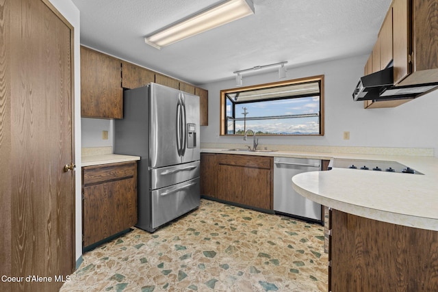1995 Long Rd, Plummer, ID 83851 - kitchen with stainless steel appliances, a sink, light countertops, exhaust hood, and a textured ceiling