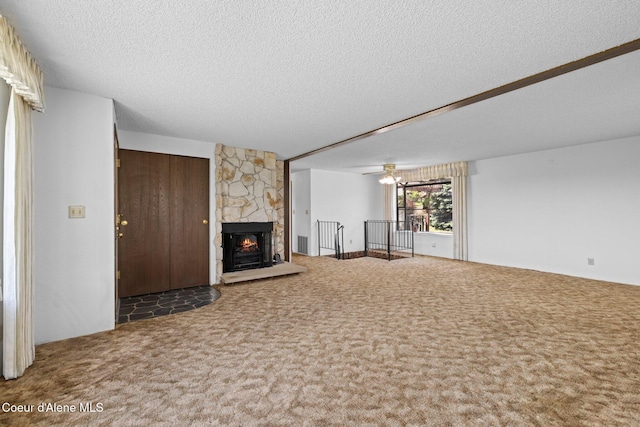1995 Long Rd, Plummer, ID 83851 - unfurnished living room featuring carpet floors, a textured ceiling, and a stone fireplace