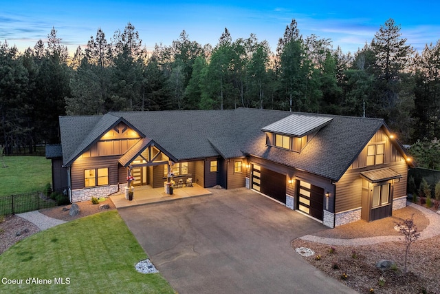 11733 N Blue Jay Loop, Hayden, ID 83835 - view of front of house featuring stone siding, asphalt driveway, an attached garage, roof with shingles, and a porch