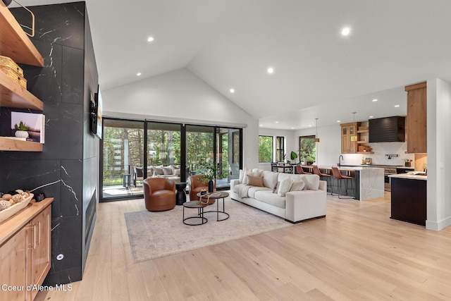 11733 N Blue Jay Loop, Hayden, ID 83835 - living room featuring recessed lighting, high vaulted ceiling, and light wood-style flooring