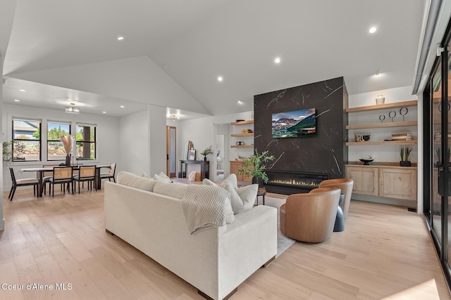 11733 N Blue Jay Loop, Hayden, ID 83835 - living room featuring light wood-style flooring, recessed lighting, a premium fireplace, and high vaulted ceiling