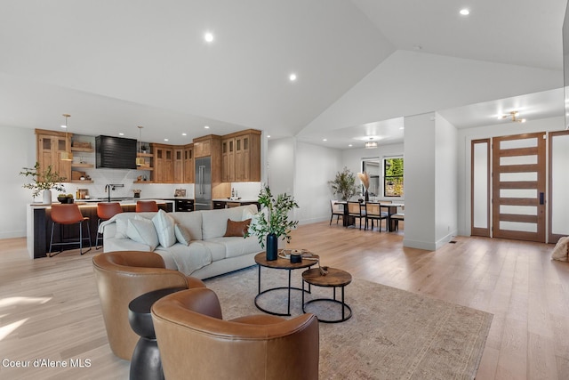 11733 N Blue Jay Loop, Hayden, ID 83835 - living room with high vaulted ceiling, light wood-style flooring, recessed lighting, and baseboards