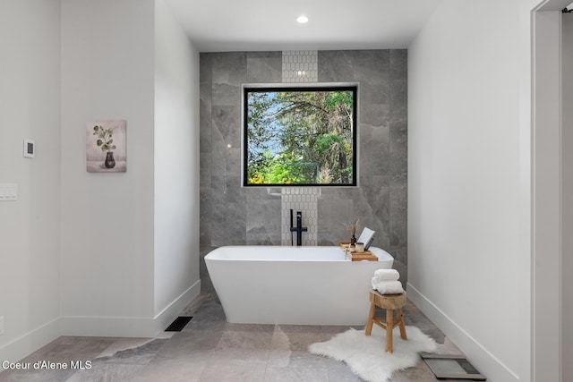 11733 N Blue Jay Loop, Hayden, ID 83835 - full bath featuring a freestanding tub, baseboards, tile walls, and recessed lighting