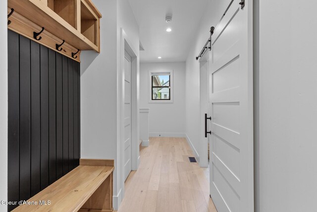 11733 N Blue Jay Loop, Hayden, ID 83835 - mudroom featuring a barn door, recessed lighting, light wood finished floors, and baseboards