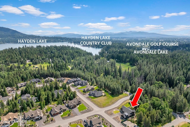 11733 N Blue Jay Loop, Hayden, ID 83835 - aerial view of property and surrounding area featuring a water and mountain view, a forest, and nearby suburban area