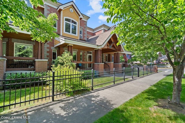303 S 11th St, Coeur Dalene, ID 83814 - view of front facade featuring brick siding and covered porch