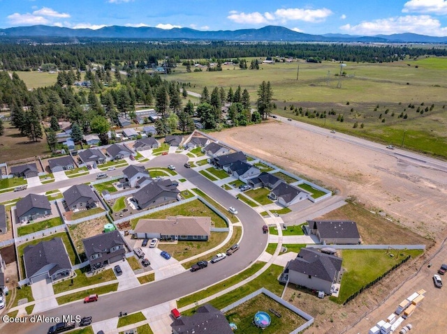 16171 N Hadley Loop, Rathdrum, ID 83858 - aerial overview of property's location with a mountain backdrop and nearby suburban area