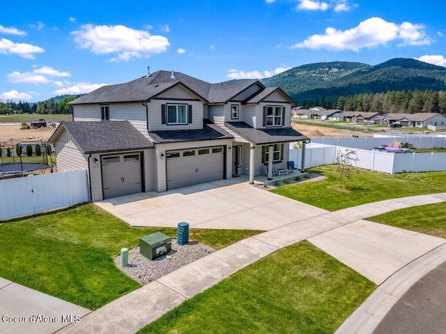 16171 N Hadley Loop, Rathdrum, ID 83858 - traditional-style home with concrete driveway, a mountain view, a garage, roof with shingles, and a residential view