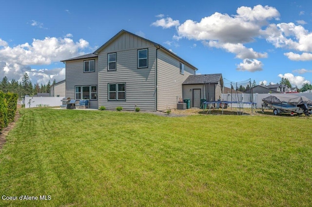 16171 N Hadley Loop, Rathdrum, ID 83858 - back of property with a trampoline, board and batten siding, and central AC unit