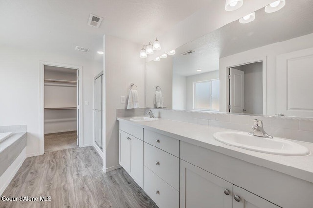 16171 N Hadley Loop, Rathdrum, ID 83858 - full bath with double vanity, a spacious closet, a stall shower, wood finished floors, and baseboards