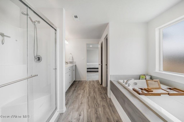 16171 N Hadley Loop, Rathdrum, ID 83858 - full bath with a stall shower, wood finished floors, a bath, and ensuite bathroom