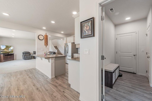 16171 N Hadley Loop, Rathdrum, ID 83858 - corridor featuring light wood-style floors, a sink, stairway, and recessed lighting