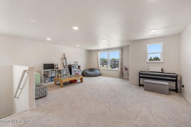 16171 N Hadley Loop, Rathdrum, ID 83858 - living area with healthy amount of natural light, carpet flooring, a textured ceiling, recessed lighting, and an upstairs landing