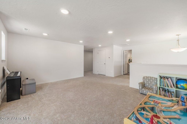 16171 N Hadley Loop, Rathdrum, ID 83858 - rec room with light colored carpet, recessed lighting, a textured ceiling, and baseboards