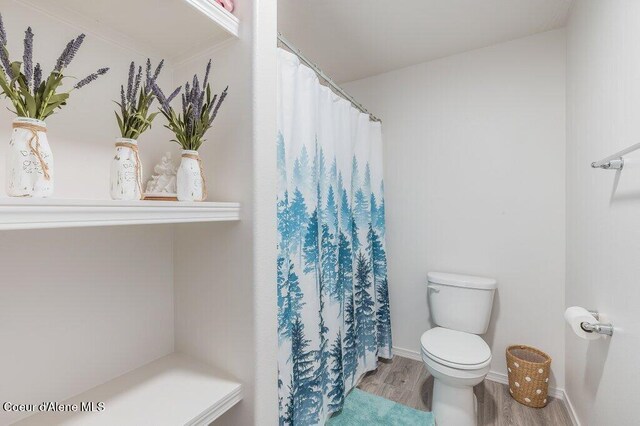 16171 N Hadley Loop, Rathdrum, ID 83858 - bathroom with toilet, wood finished floors, and a shower with curtain