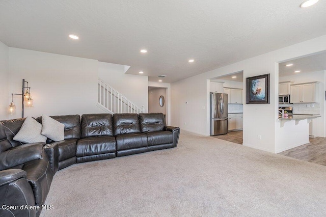 16171 N Hadley Loop, Rathdrum, ID 83858 - living room featuring light colored carpet, recessed lighting, and stairway