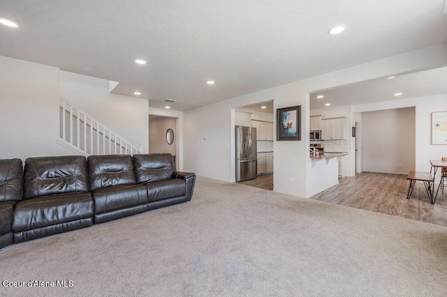 16171 N Hadley Loop, Rathdrum, ID 83858 - living area with recessed lighting, light colored carpet, and stairs