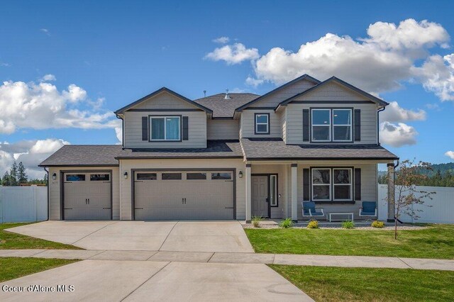 16171 N Hadley Loop, Rathdrum, ID 83858 - view of front of property featuring driveway, a porch, an attached garage, and roof with shingles