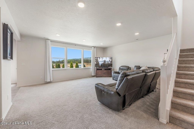 16171 N Hadley Loop, Rathdrum, ID 83858 - living room with light colored carpet, stairway, recessed lighting, a textured ceiling, and baseboards