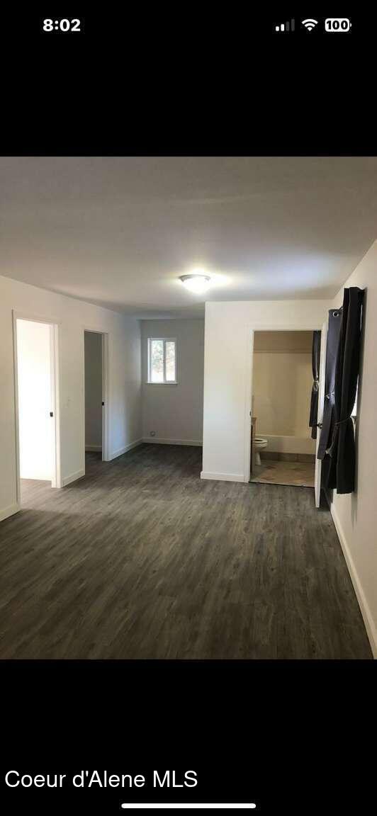 243 Pine St, Moyie Springs, ID 83845 - spare room featuring baseboards and dark wood-style flooring