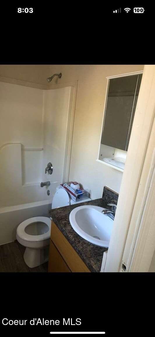 243 Pine St, Moyie Springs, ID 83845 - bathroom with vanity, bathtub / shower combination, and toilet