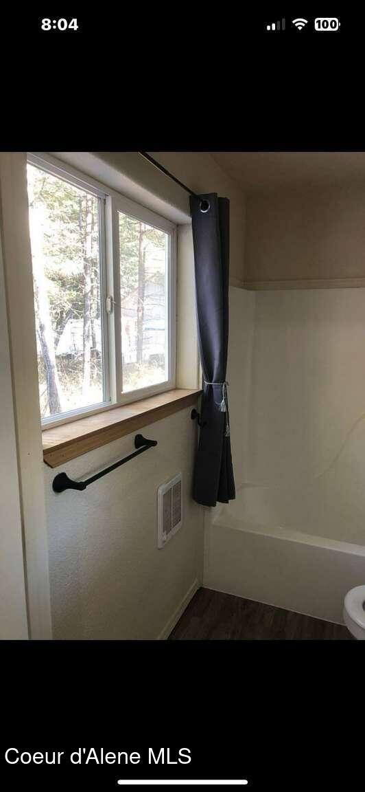 243 Pine St, Moyie Springs, ID 83845 - bathroom featuring a bath and toilet