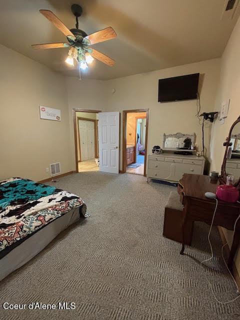 707 Patches Ln, Saint Maries, ID 83861 - bedroom with carpet floors, ceiling fan, and ensuite bath