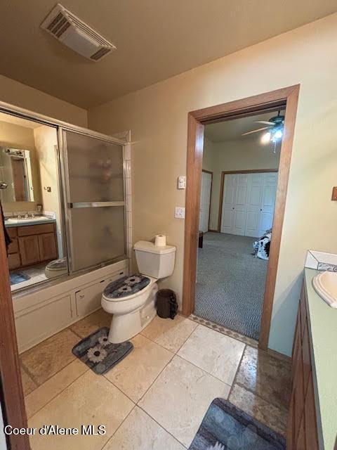 707 Patches Ln, Saint Maries, ID 83861 - full bathroom with vanity, ceiling fan, combined bath / shower with glass door, and tile patterned floors